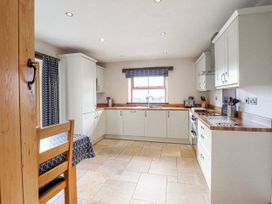 A kitchen with a table and chairs at Briws and 963354 together they sleep 35