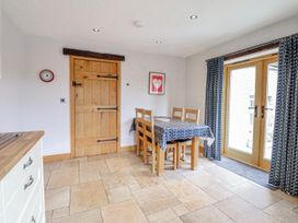 A dining room with a table and chairs at Briws and 963354 together they sleep 35