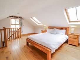 A bedroom with a bed and windows at Briws and 963354 together they sleep 35