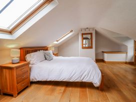 A bedroom with a bed and nightstand at Briws and 963354 together they sleep 35