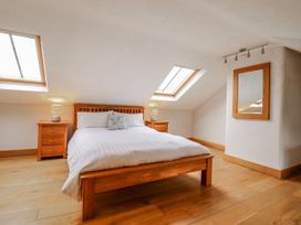 A bedroom with a bed and two nightstands at Briws and 963354 together they sleep 35