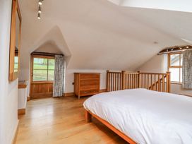 A bedroom with a bed and dresser at Briws and 963354 together they sleep 35