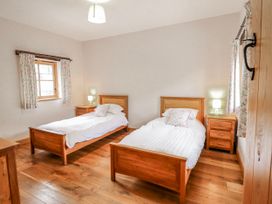 A bedroom with two single beds and a window at Briws and 963354 together they sleep 35