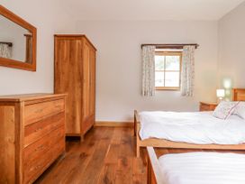 A bedroom with two beds and wooden furniture at Briws and 963354 together they sleep 35