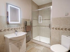 A bathroom with a shower, sink, and toilet at Briws and 963354 together they sleep 35