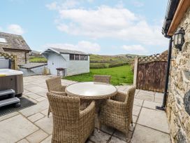 An outdoor seating area with a table and chairs at Briws and 963354 together they sleep 35