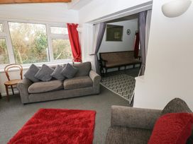 A living room with a sofa and chair at Maesgwyn in Bridell near Cardigan