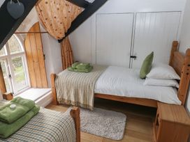 A bedroom with two beds and a window at Maesgwyn Bridell near Cardigan