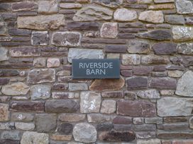 A sign on a stone wall at Riverside Barn in Gilwern near Crickhowell and Abergavenny