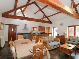 A kitchen with wooden furniture and appliances at Riverside Barn Gilwern near Crickhowell and Abergavenny