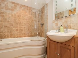 A bathroom with a shower and bathtub at Riverside Barn Gilwern near Crickhowell and Abergavenny