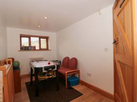 A snug with an air hockey table and chairs at Riverside Barn in Gilwern near Crickhowell and Abergavenny
