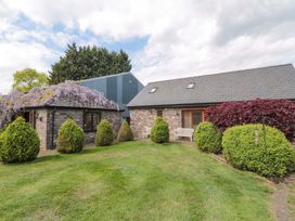 An outdoor view of a stone building with greenery at Riverside Barn Gilwern near Crickhowell and Abergavenny
