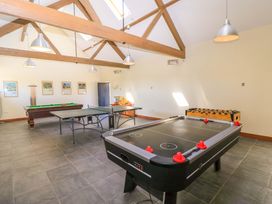 A game room with an air hockey table ping pong table pool table and foosball table at Keepers Cottage Winterborne Stickland