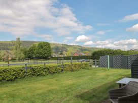 An outdoor view with grass and trees at Longside in Gilwern
