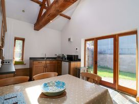 A kitchen with a table and chairs at Longside in Gilwern