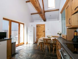 A kitchen with a table and chairs at Longside in Gilwern