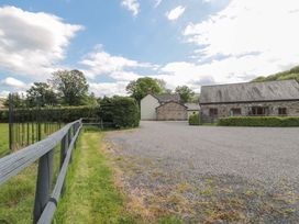 An outdoor area with gravel and buildings at Longside in Gilwern
