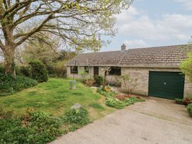 A single story house with a garage and garden with trees and a lawn at Bryn yr Haf in Llanfair Clydogau near Lampeter