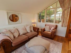 A living room with a sofa and window at Hawkrigg Cottage in Kirkby Lonsdale