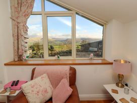 A living room with a window overlooking the countryside at Hawkrigg Cottage in Kirkby Lonsdale