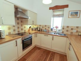 A kitchen with appliances and countertop at Hawkrigg Cottage in Kirkby Lonsdale