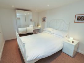 A bedroom with a bed and a dresser at Hawkrigg Cottage in Kirkby Lonsdale