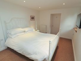 A bedroom with a bed and television at Hawkrigg Cottage in Kirkby Lonsdale