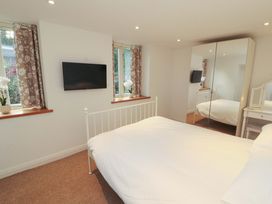 A bedroom with a bed and television at Hawkrigg Cottage in Kirkby Lonsdale