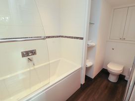 A bathroom with a bathtub and toilet at Hawkrigg Cottage Kirkby Lonsdale