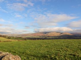 A scenic view of mountains and fields at Hawkrigg Cottage in Kirkby Lonsdale