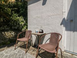 An outdoor area with two chairs and a table at Salty Puffin in Benllech