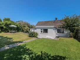 A house with a garden and outdoor table at Salty Puffin in Benllech