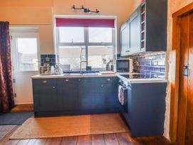 A kitchen with a sink and oven at Dovetail Cottage in Llangollen