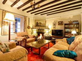 A living room with a fireplace and television at Murmur Y Don in Harlech