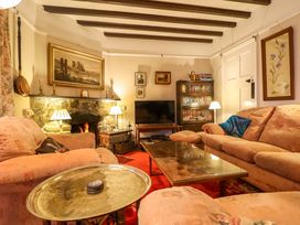 A living room with a television and a fireplace at Murmur Y Don in Harlech