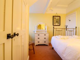 A bedroom with a bed and dresser at Murmur Y Don in Harlech