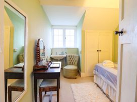 A bedroom with a bed and furniture at Murmur Y Don in Harlech