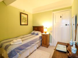 A bedroom with a bed and lamp at Murmur Y Don in Harlech