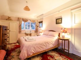 A bedroom with a bed and wardrobe at Murmur Y Don in Harlech