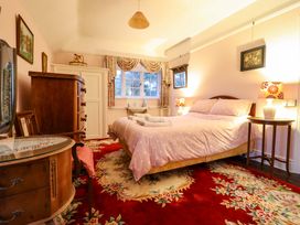 A bedroom with a bed and dresser at Murmur Y Don in Harlech