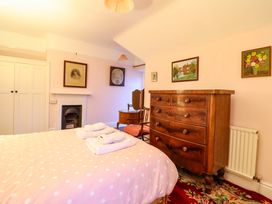 A bedroom with a bed and dresser at Murmur Y Don in Harlech