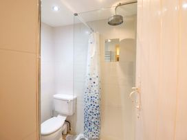 A bathroom with a toilet and shower at Murmur Y Don in Harlech