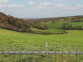 A landscape view featuring a grass field and trees at Bwthyn-y-Rhiw Penybanc near Llandeilo