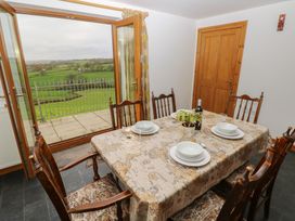A dining room with a table set for a meal at Bwthyn-y-Rhiw Penybanc near Llandeilo