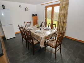 A dining room with a table set for a meal at Bwthyn-y-Rhiw Penybanc near Llandeilo