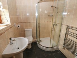 A bathroom with a shower, toilet, and wash basin at Bwthyn-y-Rhiw in Penybanc near Llandeilo
