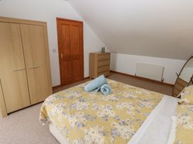 A bedroom with a bed and wardrobe at Bwthyn-y-Rhiw Penybanc near Llandeilo
