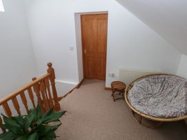 A landing with a staircase and a chair at Bwthyn-y-Rhiw Penybanc near Llandeilo