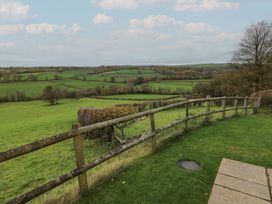 A view of green fields with a wooden fence at Bwthyn-y-Rhiw Penybanc near Llandeilo